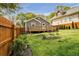 Wooden privacy fence surrounds a backyard with flower beds and lawn at 1331 Walker Ave, Atlanta, GA 30344