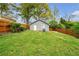 An exterior shot of the home's outbuilding with gray paint and a white entry door at 1331 Walker Ave, Atlanta, GA 30344