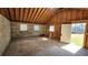 Unfinished basement featuring exposed wood rafters, concrete flooring, and natural light at 1331 Walker Ave, Atlanta, GA 30344