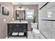 Elegant bathroom with a sleek black vanity, marble countertop, black framed mirror, and a glass-enclosed shower at 1331 Walker Ave, Atlanta, GA 30344