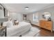 Relaxing bedroom featuring hardwood floors, a large rug, stylish furniture, neutral colors, and natural light from a window at 1331 Walker Ave, Atlanta, GA 30344