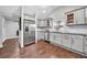 Bright kitchen featuring stainless steel appliances, granite countertops, and gray shaker cabinets at 1331 Walker Ave, Atlanta, GA 30344