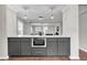 Modern kitchen with gray cabinets, stainless oven, gold hardware and decorative pendant lights over a marble countertop at 1331 Walker Ave, Atlanta, GA 30344