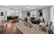 Open concept living room with hardwood floors, natural light, and seamless transition to the dining area at 1331 Walker Ave, Atlanta, GA 30344