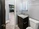 Stylish bathroom featuring a granite vanity, new mirror and lighting next to the doorway at 6095 Blackberry Ln, Buford, GA 30518