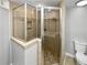 Bathroom featuring a corner shower, stylish tile surround and glass door at 6095 Blackberry Ln, Buford, GA 30518