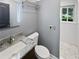 Modern bathroom with granite vanity, updated mirror and lighting and a tiled shower at 6095 Blackberry Ln, Buford, GA 30518