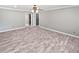 Spacious bedroom with a ceiling fan and wood-look flooring with an open closet concept at 6095 Blackberry Ln, Buford, GA 30518