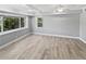 Bright bedroom featuring neutral tones, wood-look flooring, and natural light at 6095 Blackberry Ln, Buford, GA 30518