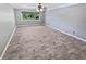 Bright bedroom with wood-look flooring and a window with a view of the trees at 6095 Blackberry Ln, Buford, GA 30518