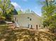 A view of the rear exterior showing the fenced backyard and brick facade at 6095 Blackberry Ln, Buford, GA 30518