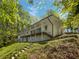 Two-story home with a large balcony overlooking the wooded lot at 6095 Blackberry Ln, Buford, GA 30518