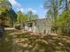Charming exterior of the home featuring brick, wood shutters, and a fenced backyard at 6095 Blackberry Ln, Buford, GA 30518