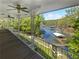 Picturesque lake view from a spacious balcony, showcasing lush trees, boat docks, and serene water at 6095 Blackberry Ln, Buford, GA 30518