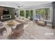 Bright living room featuring a cozy fireplace, neutral tones and lake views at 6095 Blackberry Ln, Buford, GA 30518