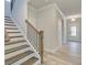 Elegant staircase with dark wood and wrought-iron railing leading to the second floor at 4443 Eastbrook Pl, Snellville, GA 30039