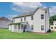 Rear exterior view with screened in porch and well manicured lawn at 409 West March Cir, Loganville, GA 30052