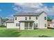 Two-story white house with screened in porch, and green lawn at 409 West March Cir, Loganville, GA 30052