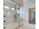 Bathroom featuring glass shower with tile surround, bench, and a walk-in closet with shelving at 409 West March Cir, Loganville, GA 30052