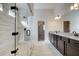 Luxurious bathroom features a glass shower, granite countertops, and and sinks at 409 West March Cir, Loganville, GA 30052
