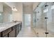 Bathroom with granite countertops, double sinks, and a glass shower at 409 West March Cir, Loganville, GA 30052