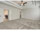 Spacious bedroom features a tray ceiling and plush carpeting at 409 West March Cir, Loganville, GA 30052