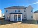 Backyard view of two-story home with a covered patio, ideal for outdoor living and entertaining at 409 West March Cir, Loganville, GA 30052