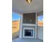 Covered patio featuring a cozy fireplace with shingle siding, perfect for outdoor gatherings at 409 West March Cir, Loganville, GA 30052