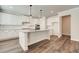 Bright kitchen featuring white cabinetry, granite countertops, stainless steel appliances, and a central island at 409 West March Cir, Loganville, GA 30052