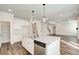 Kitchen island with stainless steel appliances, granite countertops, with a view to the living room fireplace at 409 West March Cir, Loganville, GA 30052