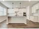 Modern kitchen with white cabinets, granite countertops, stainless steel appliances, and a large island at 409 West March Cir, Loganville, GA 30052