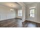 Living room with wainscoting, window, hard wood floors and chandelier at 409 West March Cir, Loganville, GA 30052