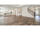 Open floor plan showcasing wood floors, white cabinets, and a staircase with iron railings, providing a modern aesthetic at 409 West March Cir, Loganville, GA 30052