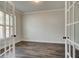 Office space with French doors, neutral walls, white trim and hardwood floors at 409 West March Cir, Loganville, GA 30052