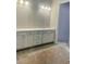 Bright bathroom featuring a vanity with a white countertop and cabinetry, illuminated by modern vanity lighting at 7375 Winderlea Ln, Cumming, GA 30040