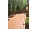 Expansive wooden back deck with room for outdoor seating and overlooking the wooded backyard at 532 Goldfinch Way, Stockbridge, GA 30281