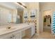 Bright bathroom with vanity, tile accents, and linen storage with an adjacent dressing area at 532 Goldfinch Way, Stockbridge, GA 30281