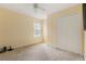 Cozy bedroom with neutral carpet, a ceiling fan, and a double-door closet at 532 Goldfinch Way, Stockbridge, GA 30281