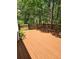 A stained wooden deck is perfect for outdoor entertaining with private views of the lush landscaping at 532 Goldfinch Way, Stockbridge, GA 30281