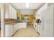 Spacious kitchen with white cabinets, tile countertops, and a cozy breakfast nook at 532 Goldfinch Way, Stockbridge, GA 30281