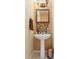 Stylish powder room featuring a pedestal sink, mosaic tile backsplash, and decorative vanity lighting at 532 Goldfinch Way, Stockbridge, GA 30281