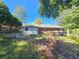 A backyard view of a single-story brick home with a detached garage at 3801 Orchard Se Rd, Smyrna, GA 30080