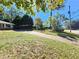 Brick ranch on a green lot with mature landscaping, as seen from the driveway at 3801 Orchard Se Rd, Smyrna, GA 30080