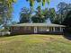 Charming brick home on a large lot with mature trees and a green lawn at 3801 Orchard Se Rd, Smyrna, GA 30080