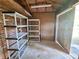 The interior of a storage shed, complete with brick, shelving, and a back door at 3801 Orchard Se Rd, Smyrna, GA 30080