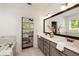 Bathroom with double vanity, soaking tub and view into bedroom at 3217 Rockbridge Rd, Avondale Estates, GA 30002