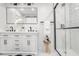 Modern bathroom with white cabinets, herringbone tile shower, and black fixtures at 3611 Hillsborough Ln, Decatur, GA 30032