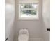 Small bathroom with white toilet and window at 3611 Hillsborough Ln, Decatur, GA 30032