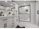 Modern bathroom with white cabinets, herringbone tile shower, and black fixtures at 3611 Hillsborough Ln, Decatur, GA 30032