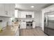 Modern kitchen boasts white cabinets, granite counters, and stainless steel appliances at 3611 Hillsborough Ln, Decatur, GA 30032
